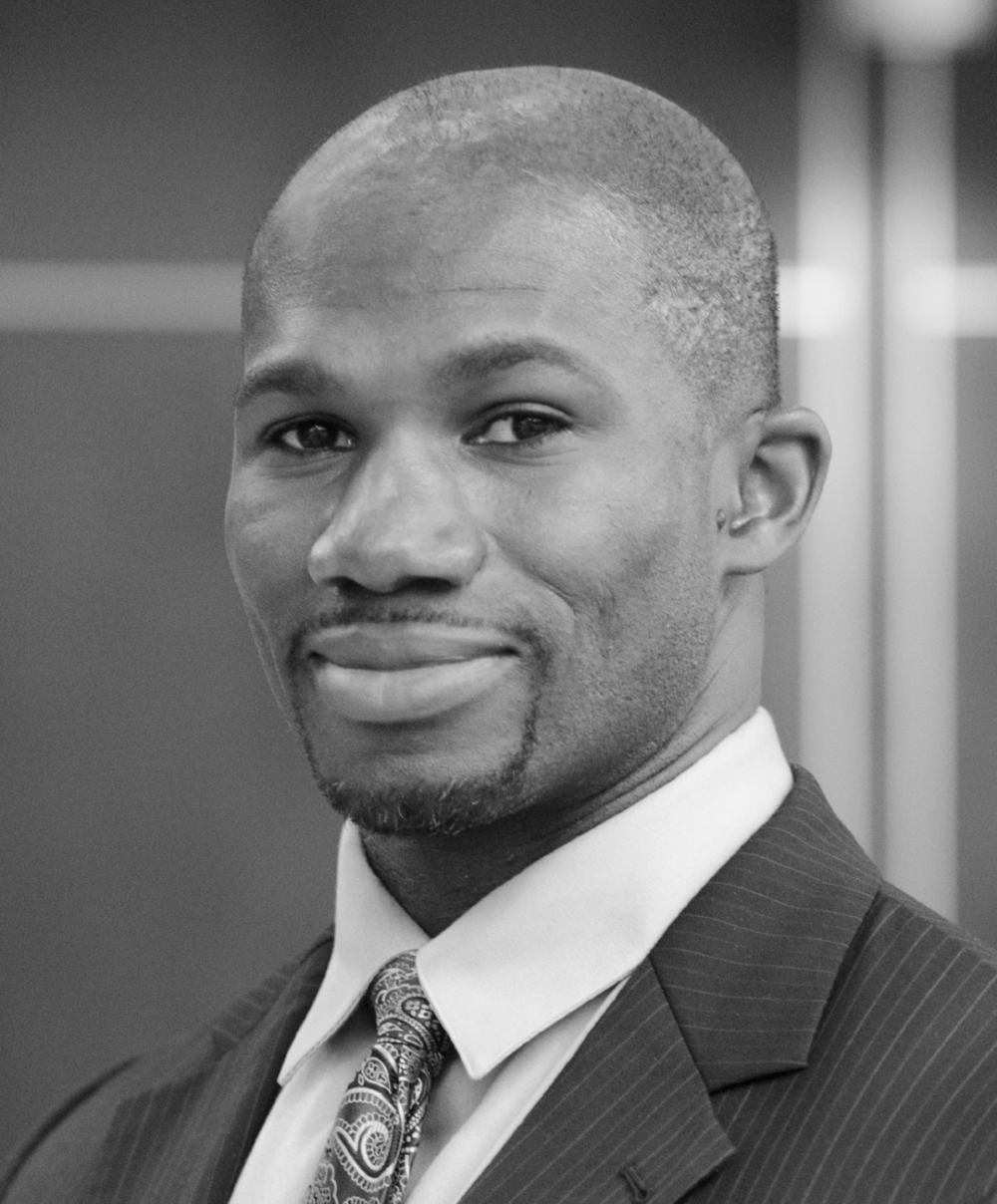 Black and white head shot of biomedical engineer Bolu Ajiboye