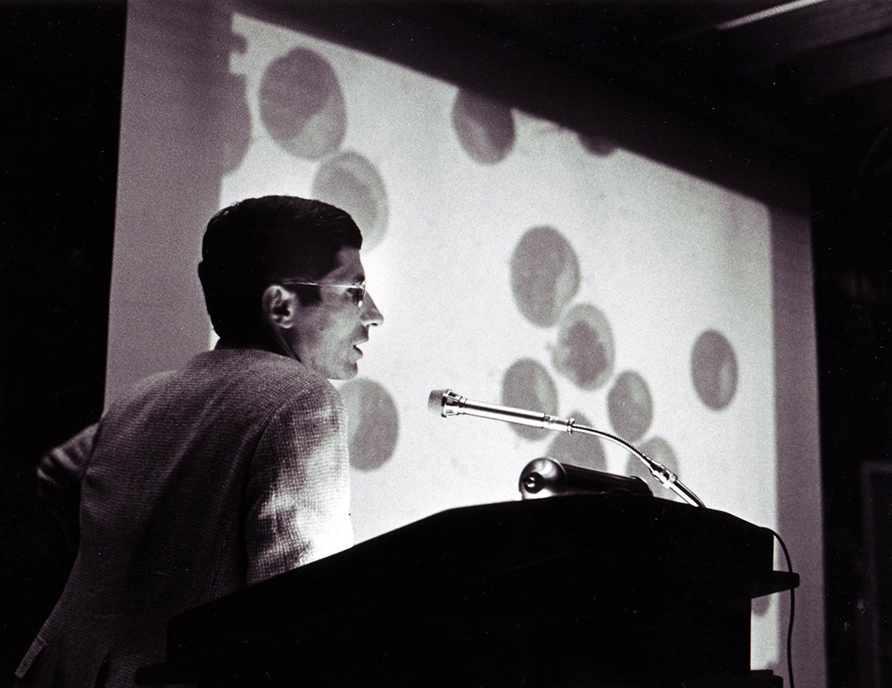 A photograph of Anthony Fauci speaking at NIAID in 1985