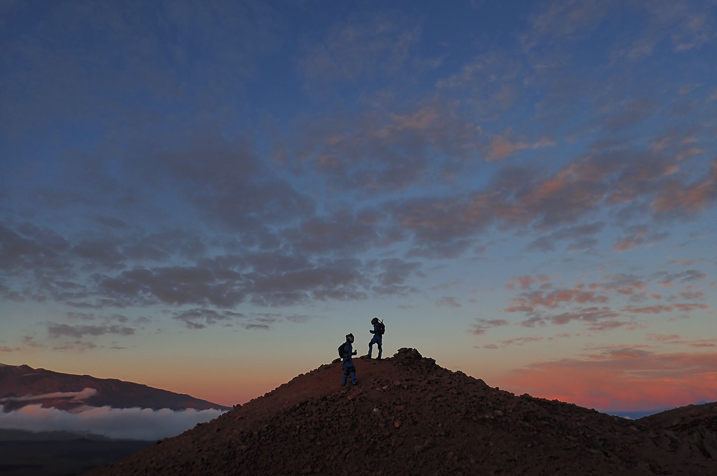 A photograph of two scientists exploring the hawaiian landscape during an EVA.