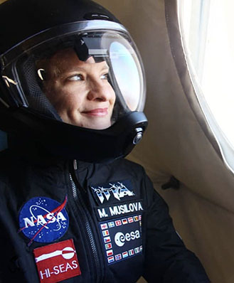 A portrait of HI-SEAS director Michaela Musilova sitting by a window..