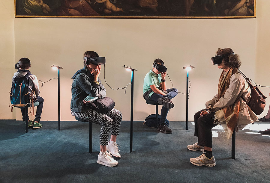 People engaging in a game with a VR headset.